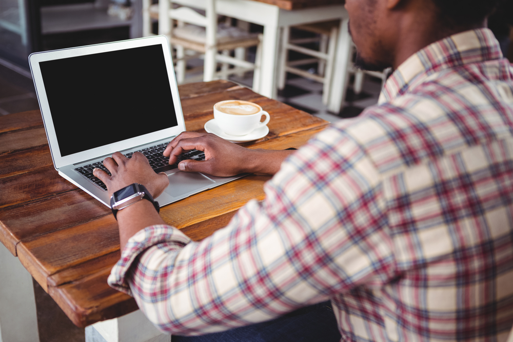 Man using laptop in cafeteria-1